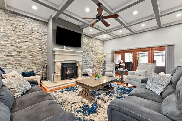 a living room with furniture a flat screen tv and a fireplace