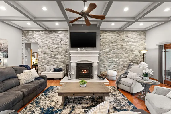 a living room with furniture a flat screen tv and a fireplace