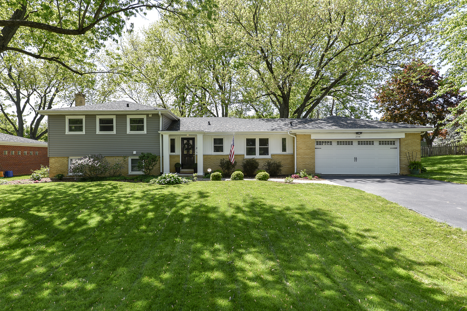 256 Sharon Drive Barrington, IL 60010 - Photo 1 of 23 a front view of a house with a garden and trees