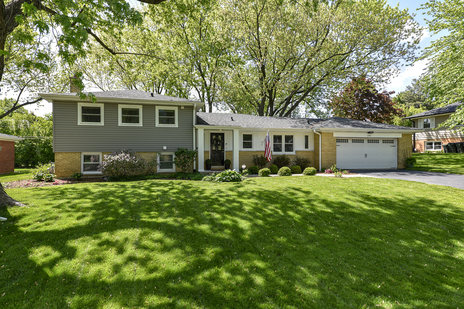 256 Sharon Drive Barrington, IL 60010 - Photo 2 of 23 a front view of a house with a garden