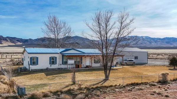 a view of a white house with a yard covered with snow