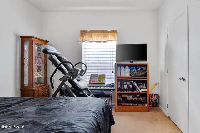 a bedroom with furniture and a window