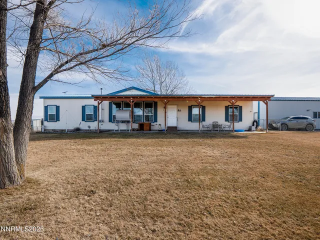 a front view of house with yard and seating area