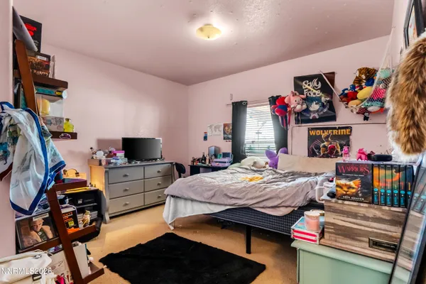 a bed room with a bed and a flat screen tv