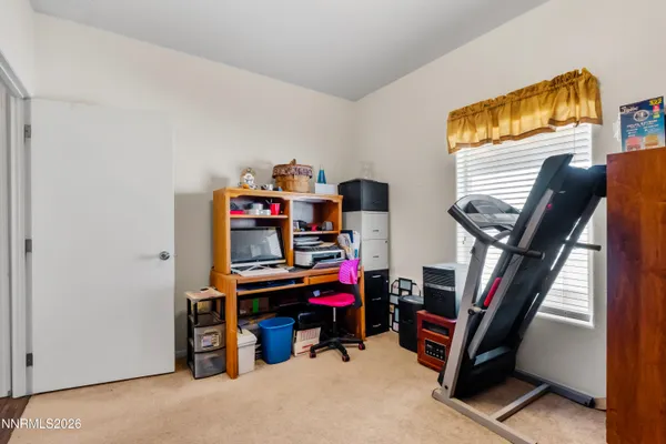 a view of an empty room with workspace and windows