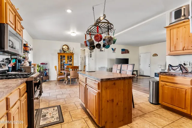 a kitchen with stainless steel appliances granite countertop a lot of cabinets a stove and a refrigerator