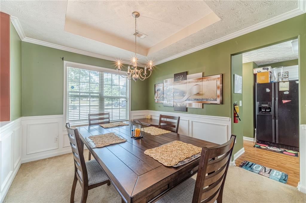 1185 Wendy Way Winder, GA 30680 - Photo 11 of 43 a dining room with furniture a chandelier and window