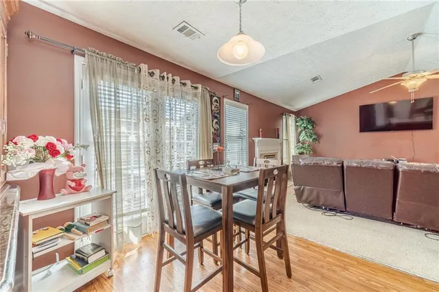 a view of a dining room with furniture window and wooden floor