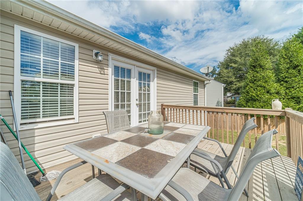 1185 Wendy Way Winder, GA 30680 - Photo 19 of 43 a view of a deck with a table and chairs