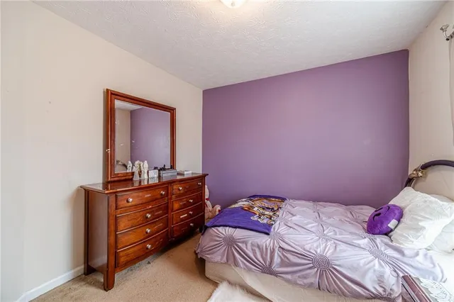 a bedroom with a bed and a dresser in it