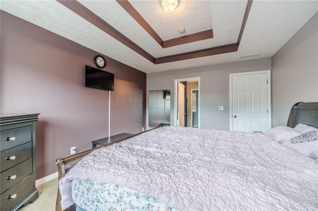 1185 Wendy Way Winder, GA 30680 - Photo 24 of 43 a bedroom with a bed and a dresser