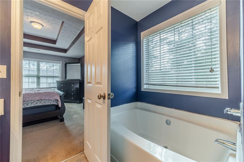 1185 Wendy Way Winder, GA 30680 - Photo 28 of 43 a en suite bathroom with a tub shower and sink