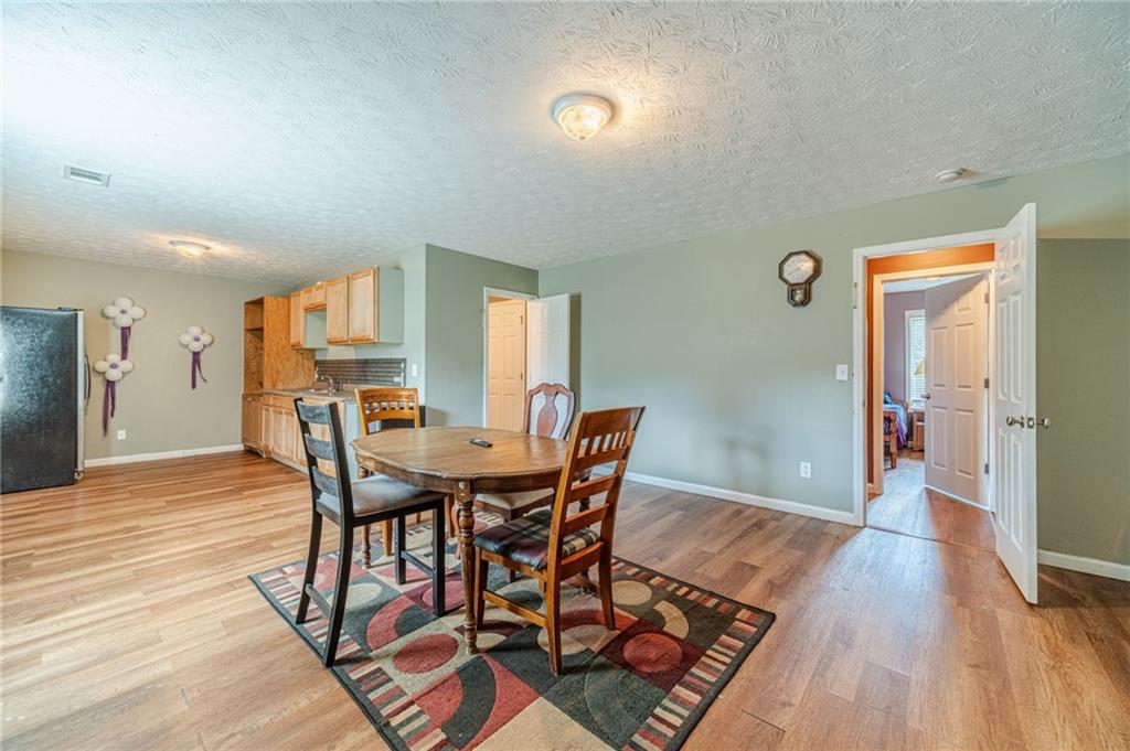 1185 Wendy Way Winder, GA 30680 - Photo 34 of 43 a view of a dining room with furniture and wooden floor
