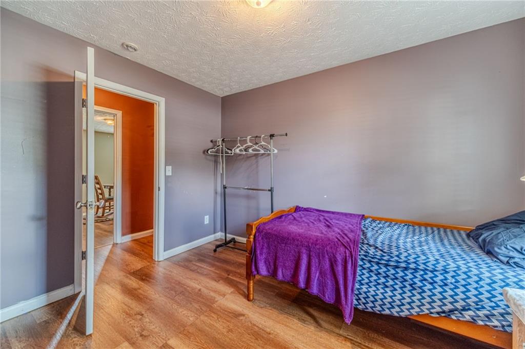 1185 Wendy Way Winder, GA 30680 - Photo 38 of 43 a bedroom with a bed and wooden floor