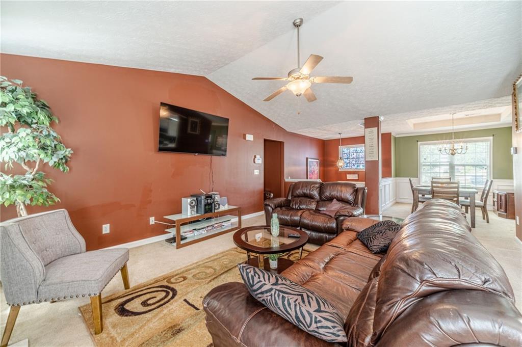 1185 Wendy Way Winder, GA 30680 - Photo 9 of 43 a living room with furniture a flat screen tv and a window