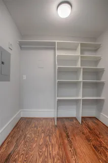 a view of a room with wooden floor and closet