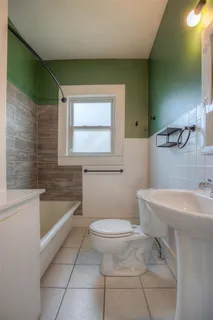 a bathroom with a sink a toilet and bathtub