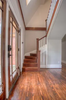 a view of entryway and hall with wooden floor
