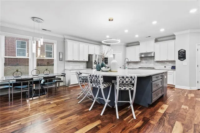 a spacious bathroom with double vanity and a mirror