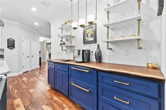 a large kitchen with stainless steel appliances granite countertop a large counter top and a stove