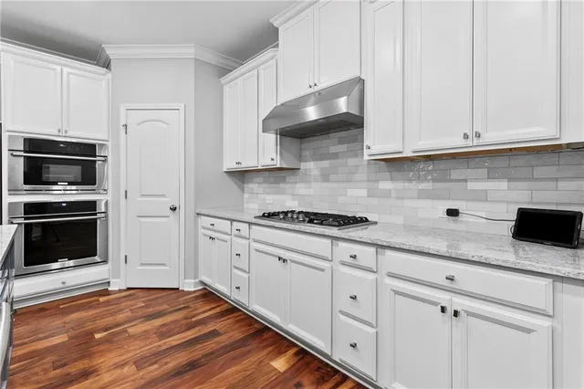 a kitchen with stainless steel appliances and wooden cabinets