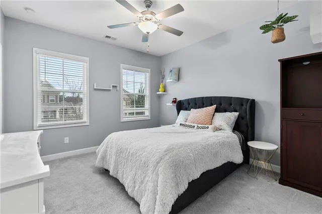 a bedroom with a large bed and a chandelier