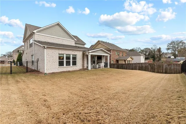 a front view of a house with a yard and potted plants