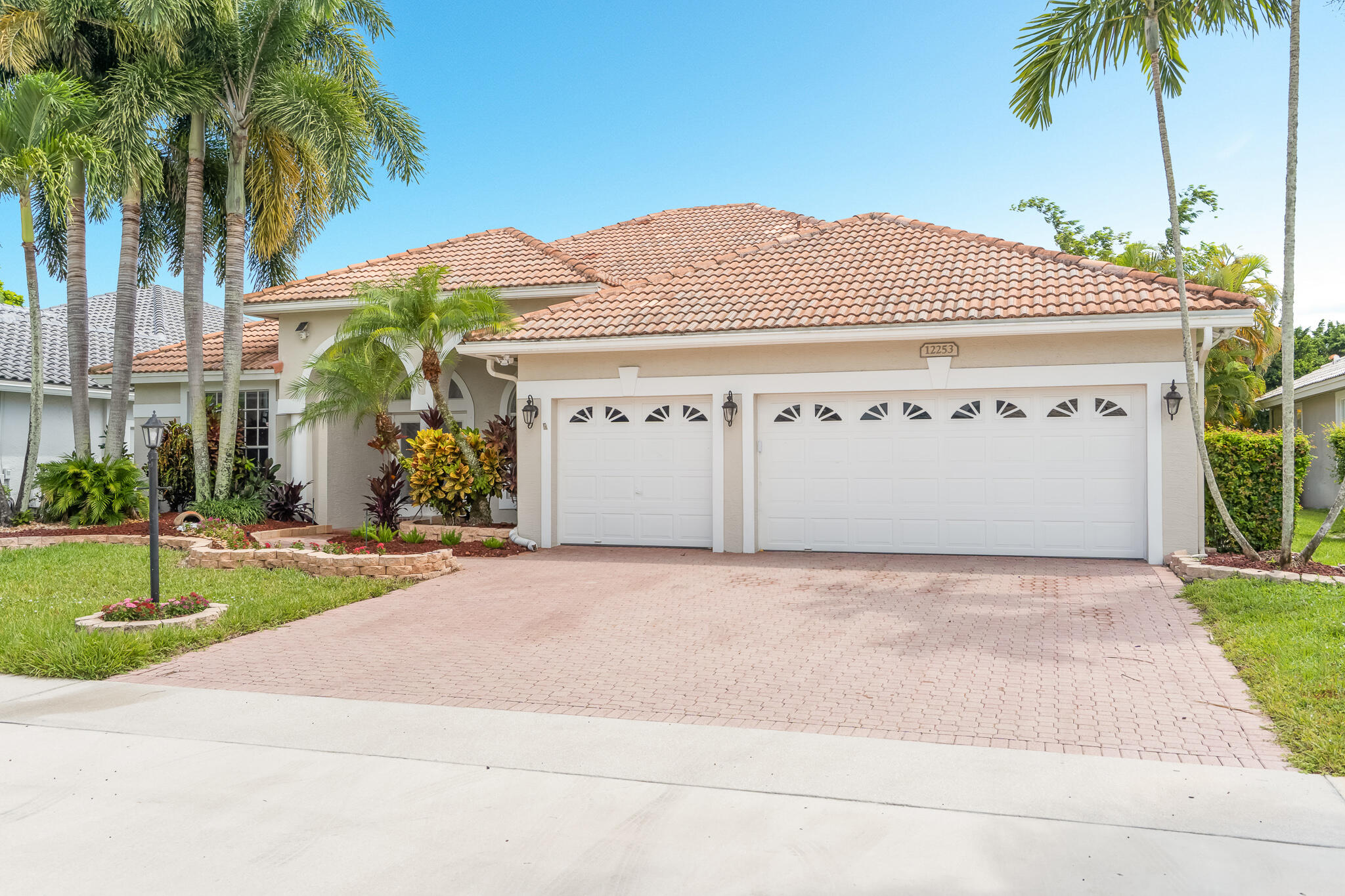 12253 Rockledge Circle Boca Raton, FL 33428 - Photo 1 of 36 a front view of house with yard and green space