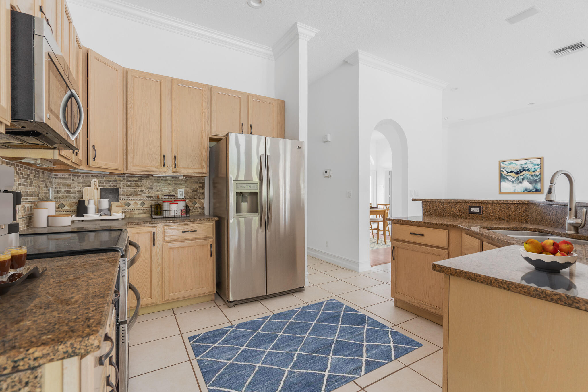 12253 Rockledge Circle Boca Raton, FL 33428 - Photo 14 of 36 a kitchen with stainless steel appliances granite countertop a refrigerator a stove and a sink