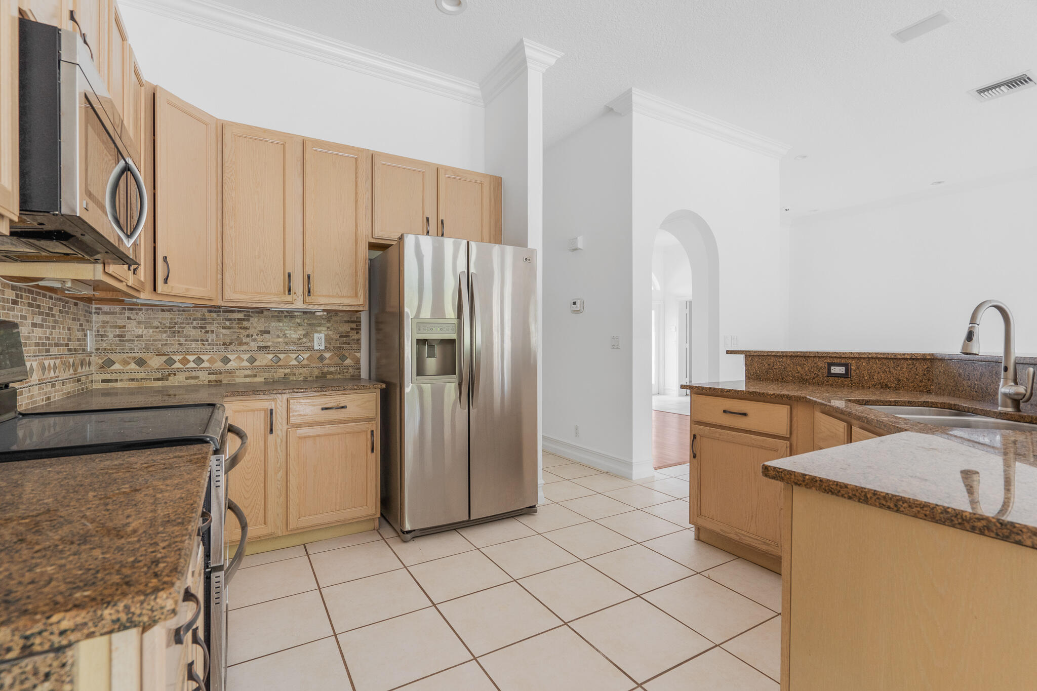 12253 Rockledge Circle Boca Raton, FL 33428 - Photo 15 of 36 a kitchen with a refrigerator sink and cabinets