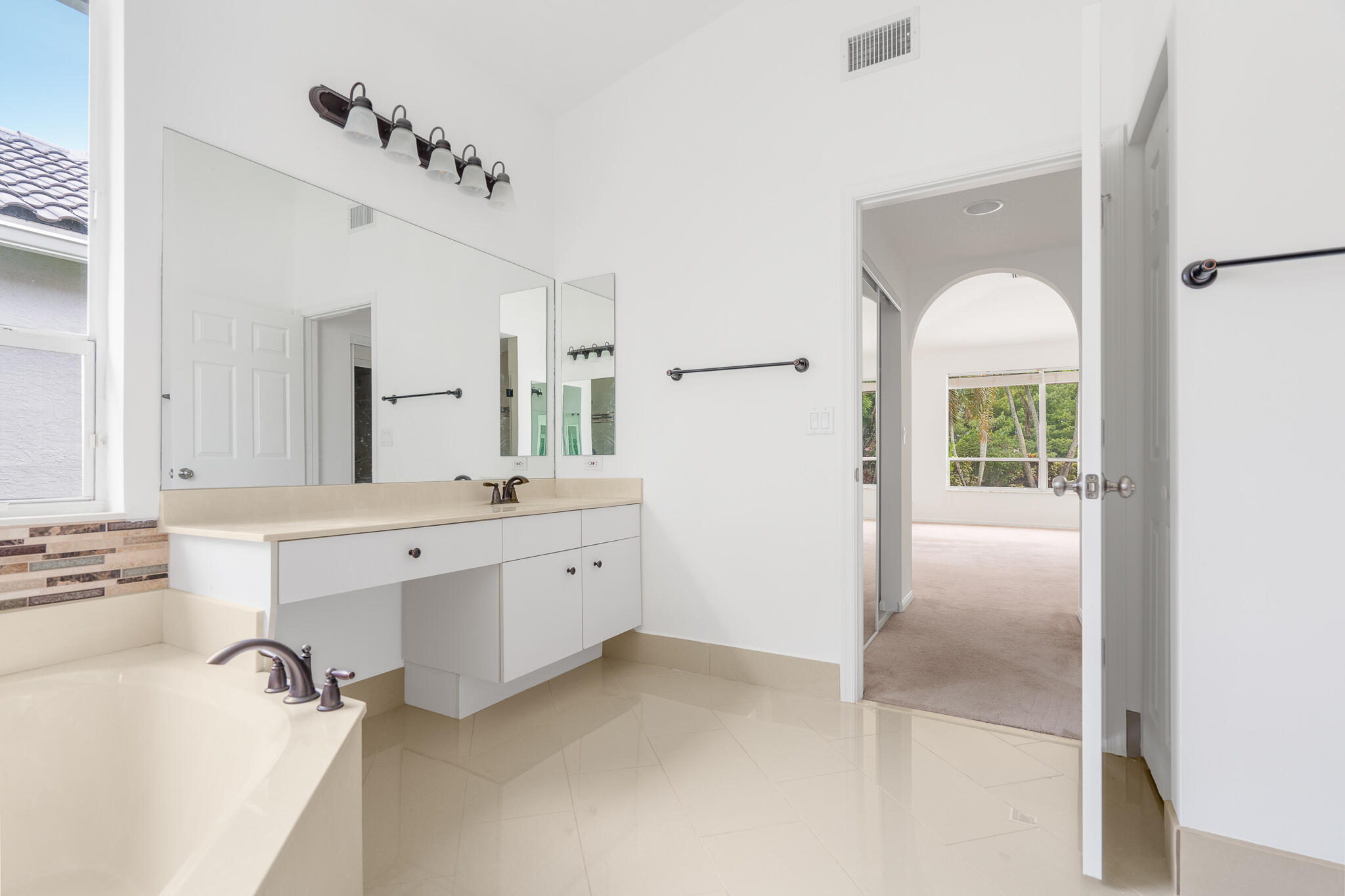 12253 Rockledge Circle Boca Raton, FL 33428 - Photo 22 of 36 a bathroom with a tub sink and mirror