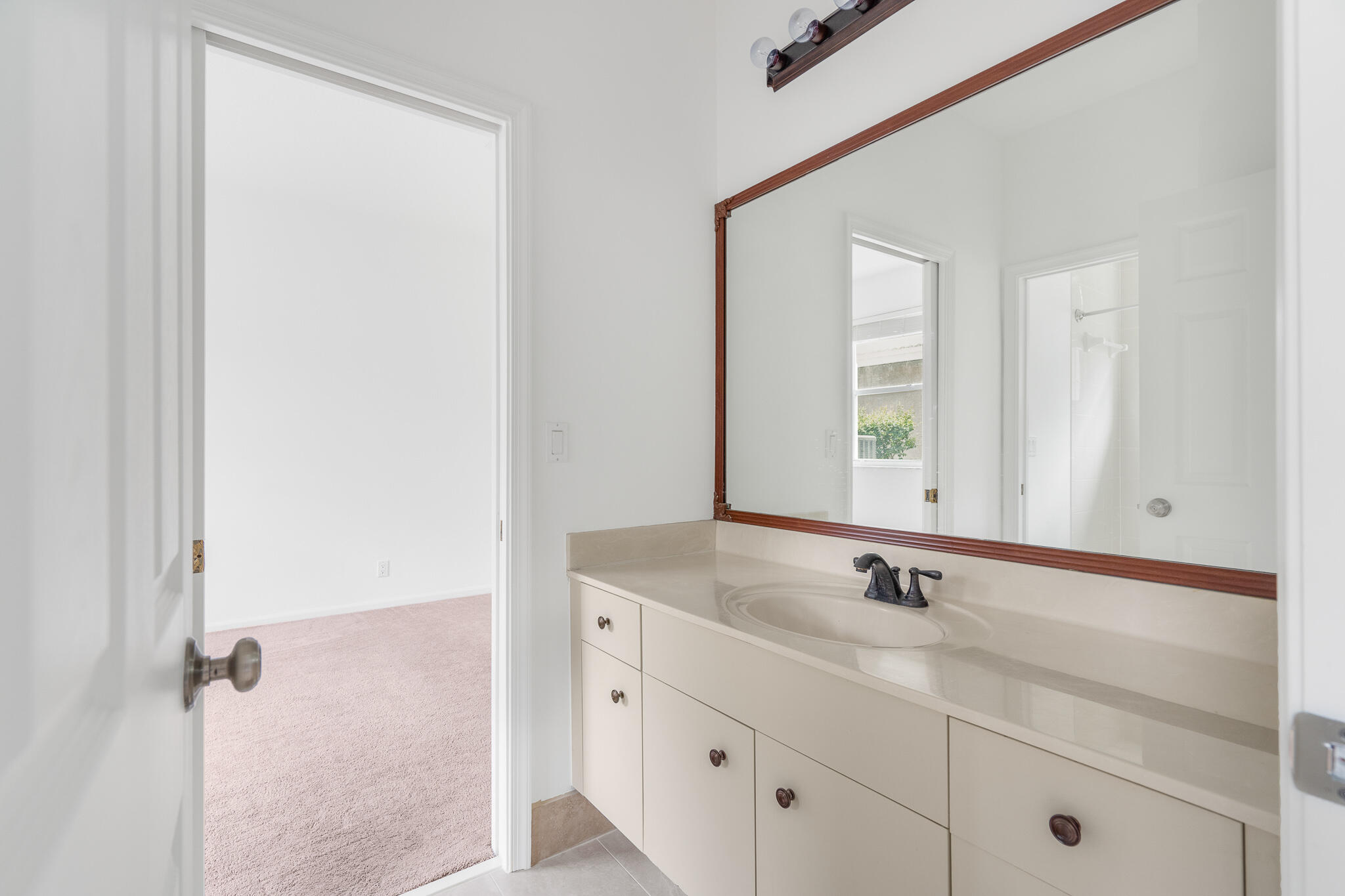 12253 Rockledge Circle Boca Raton, FL 33428 - Photo 26 of 36 a bathroom with a sink and a mirror