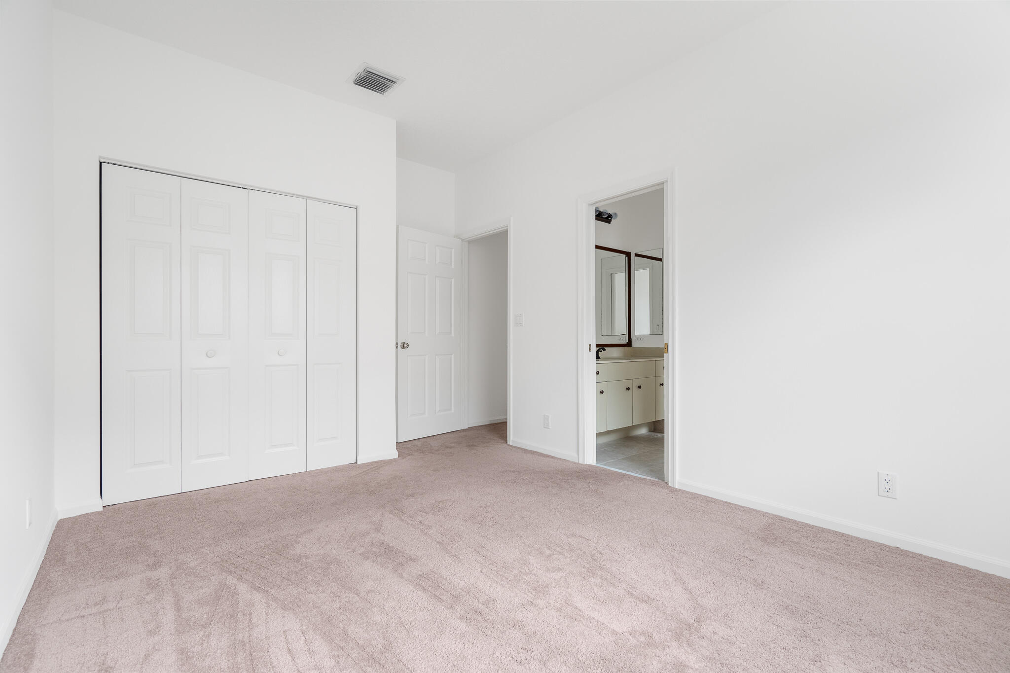 12253 Rockledge Circle Boca Raton, FL 33428 - Photo 27 of 36 a view of empty room with wooden floor and kitchen