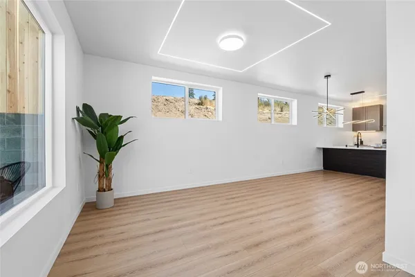 a view of a room with wooden floor and potted plant