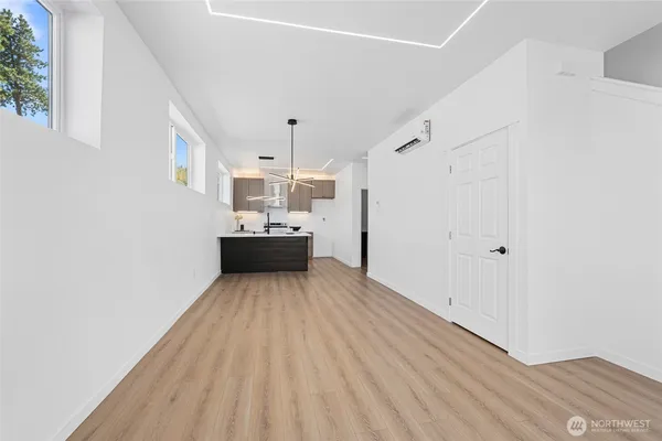 a view of a room with wooden floor