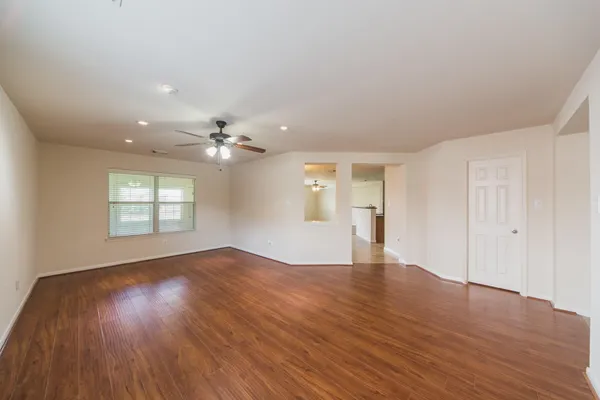 wooden floor in an empty room with a window