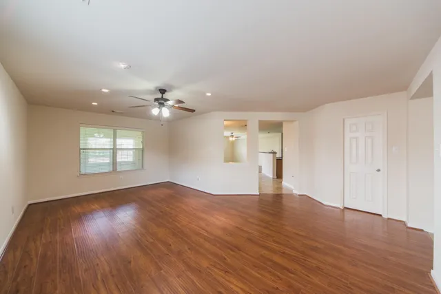 wooden floor in an empty room with a window