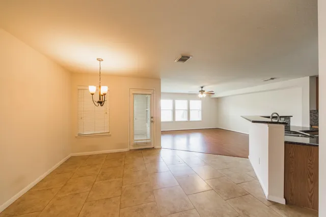 a kitchen with stainless steel appliances granite countertop a refrigerator a stove top oven a sink dishwasher and wooden floor