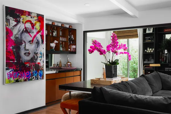 a living room with furniture and flowers