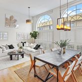 a living room with furniture a chandelier and a table