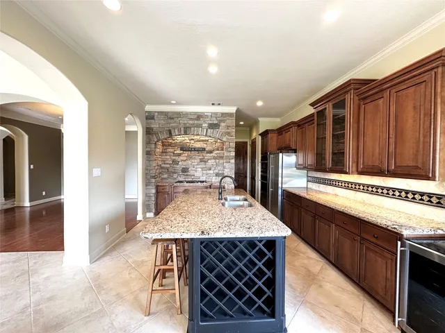 a kitchen with stainless steel appliances kitchen island granite countertop a sink and cabinets