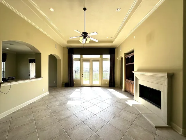 a view of an empty room with a fireplace and a window
