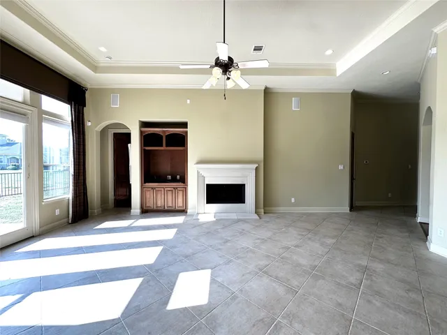 a view of an empty room with a fireplace and a window