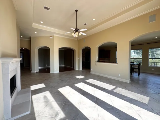a view of a room with chandelier fan and wooden floor