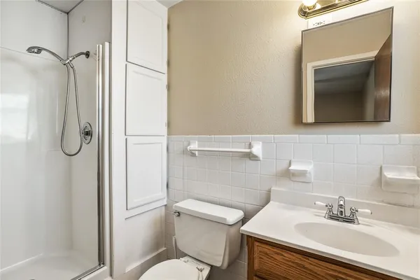 a bathroom with a sink toilet and shower