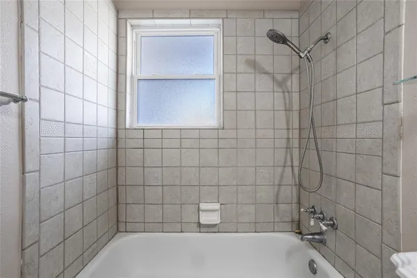 a bathroom with a bathtub and shower