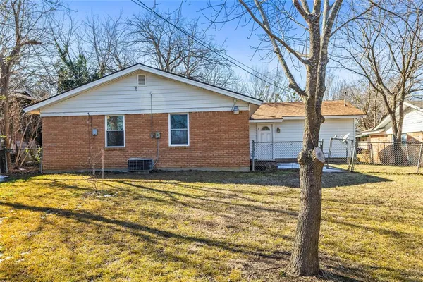 a house that has a tree in front of it