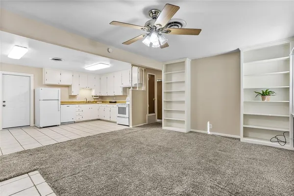 a view of a kitchen with a sink and a refrigerator