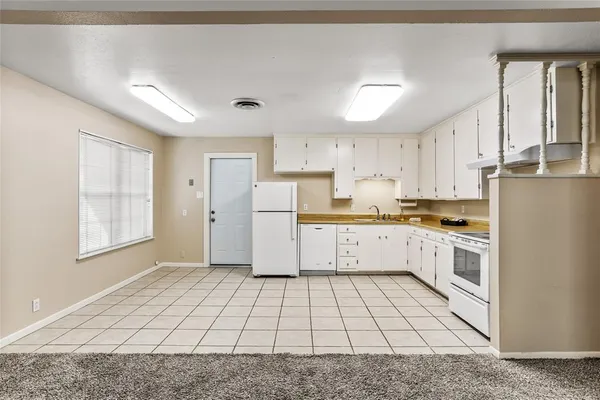 a kitchen with cabinets and white appliances