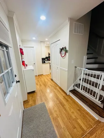 a view of an entryway with wooden floor